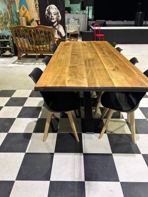 a table and chairs in a room with a black and white checkered floor