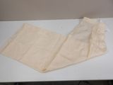 a white table with a pair of pants on it