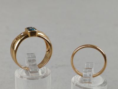two gold rings with a blue stone on top of them