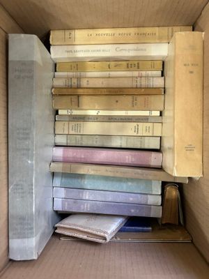 a box full of books that are stacked on top of each other