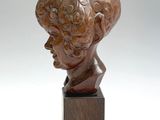sculpture of a bust of a man on a wooden base