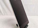 a tablet computer sitting on a stand on a white surface