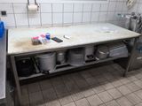 a sink in a public restroom with a lot of trash on the counter