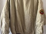 the jacket is hanging on a hanger on the wall