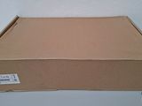 an open cardboard box sitting on top of a white table