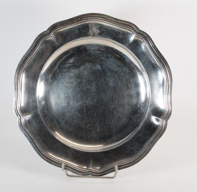 an antique silver plate on a stand on a white background