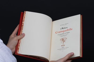 a person holding an open book in their hands
