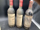 three bottles of wine sitting next to each other on a table