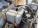 an old engine sitting in the back of a truck