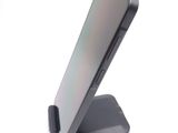 a phone that is sitting on a stand on a table