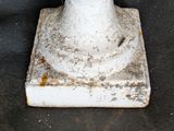 a white fire hydrant sitting on a black surface