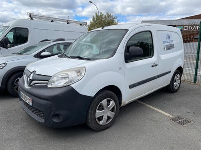 a white van parked in a parking lot next to other cars