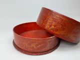 pair of red lacquered bowls with gold designs on them