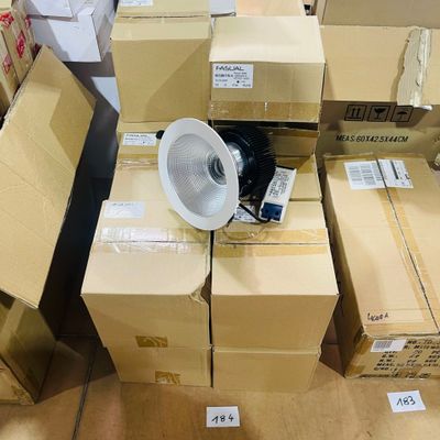 a lot of boxes and a fan in the middle of the room