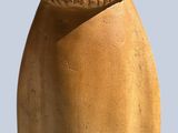 a clay jar with an acorn on top of it