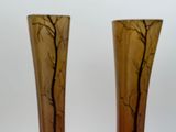 two vases that have been decorated with trees on them
