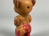 a small figurine of a teddy bear with a hat on his head