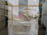 a large pile of boxes in a warehouse with plastic covering them