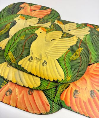 three placemats with birds on them on a white surface