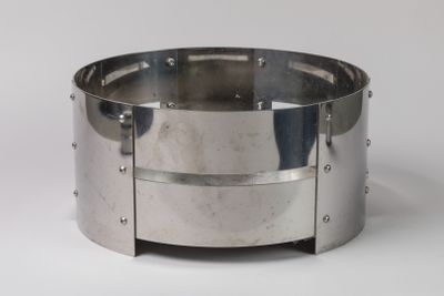 a silver bracelet with rivets on it on a white surface