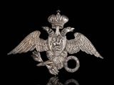 a close up of a metal bird with a crown on it ' s head