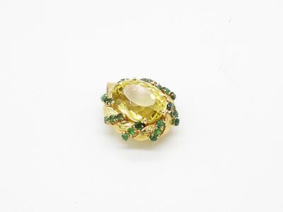 a close up of a yellow and green ring on a white surface