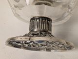 a silver plate with a glass on it on a table