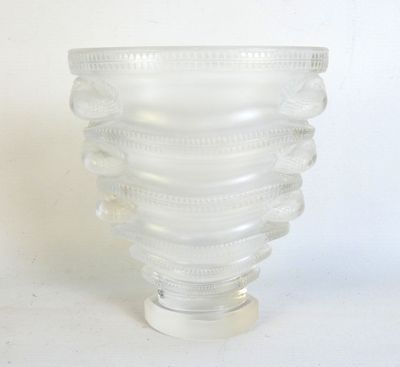 a glass vase that has a spiral design on it
