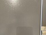 a refrigerator that is sitting on a table in a room
