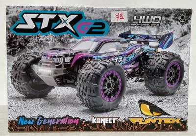 une photo d'un monster truck miniature dans sa boîte