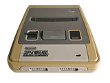 a nintendo game console sitting on top of a white surface