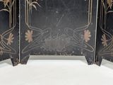 a black room divider with gold flowers on it