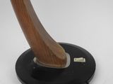 a close up of a wooden lamp on a black base