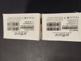 two white tickets on a black surface