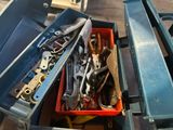 a box full of tools that are sitting on the floor