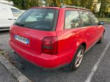 a red car that is parked in a parking lot