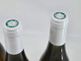 three bottles of wine sitting next to each other on a table