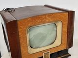 a small television sitting on top of a white table