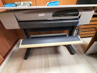 a printer sitting on top of a desk in a room
