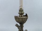 an antique silver plated candle holder with a boy holding a candle