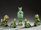 several figurines of animals and a man in a green dress