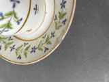 a cup and saucer sitting on top of a saucer