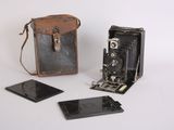 a small camera and a small case on a white surface