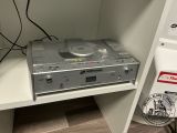 a stereo player sitting on a shelf in the corner of a room