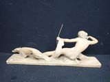 statue of a man on a horse with a spear and a dog