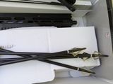 four arrows stuck in a box with some paper