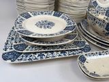 many plates and bowls on the table with blue and white designs