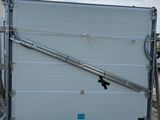 a white garage door with a metal handle on a pallet