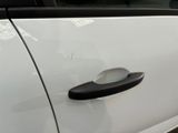 a close up of a door handle on a white car