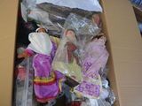 a cardboard box full of dolls and other items